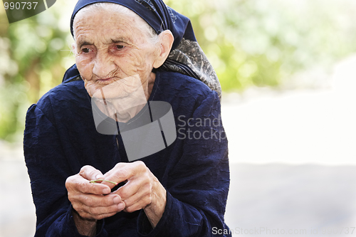 Image of Senior woman eating cherry