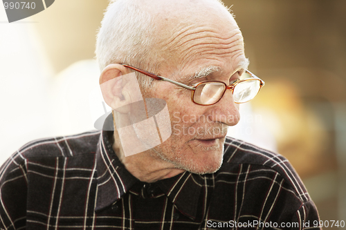 Image of Senior man in eyeglasses outdoor portrait