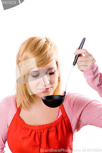 Image of young housewife with soup ladle