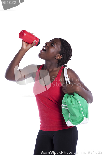 Image of Athlete woman drinking water