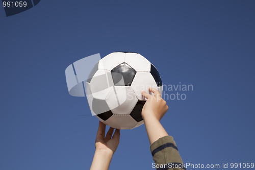 Image of Hands holding a soccer ball