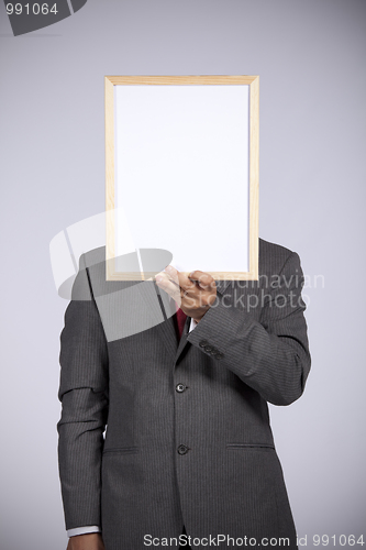 Image of businessman holding a whiteboard