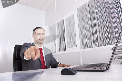 Image of Mature businessman at the office pointing to you