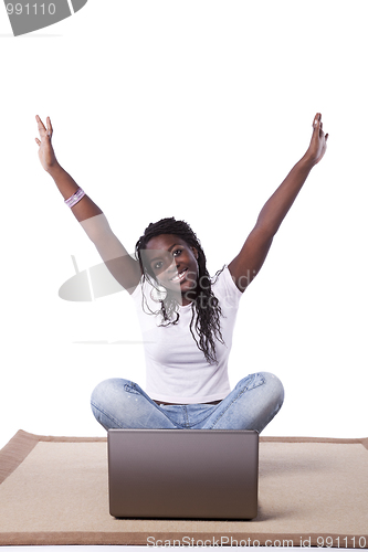 Image of young african woman working with her laptop