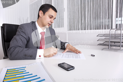 Image of Mature businessman working at the office