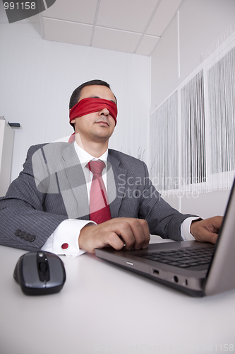 Image of Blindfold businessman working with his laptop