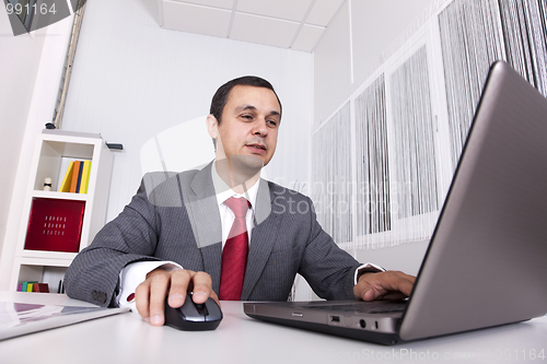 Image of Mature businessman working at the office