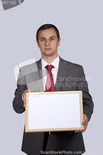 Image of businessman holding a whiteboard