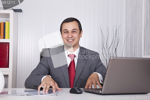 Image of Mature businessman working at the office