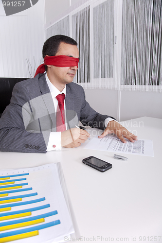 Image of Blindfold businessman working with his laptop