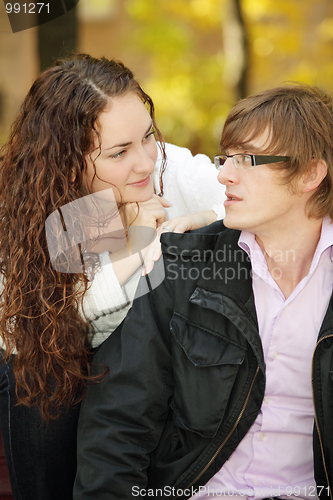 Image of Young couple talking in park