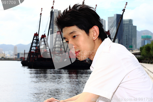Image of asia man relax in the park in the city 