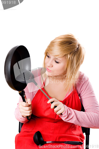 Image of  housewife with kitchen utensil