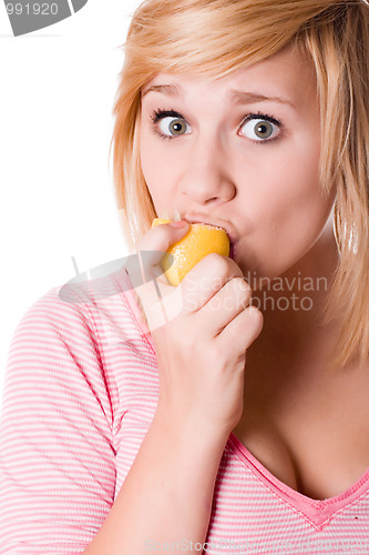 Image of young girl eating lemon