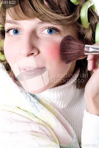 Image of  woman applying make-up 