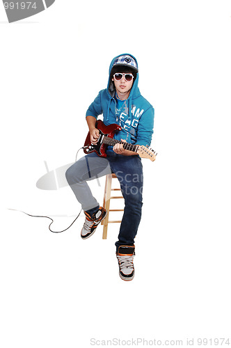 Image of Teen boy with guitar.