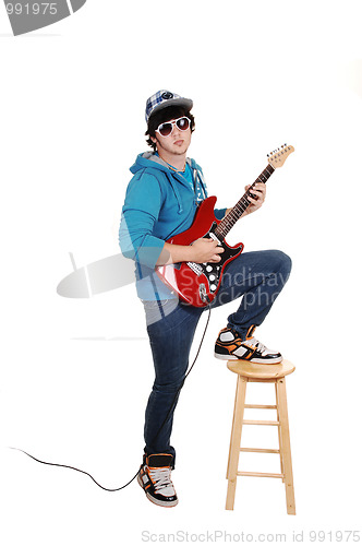 Image of Teen boy with guitar.