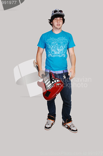 Image of Boy standing with guitar.