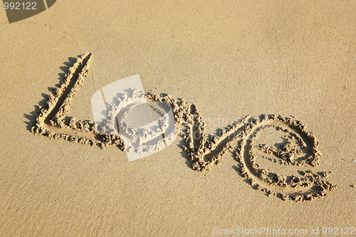 Image of love write on sand