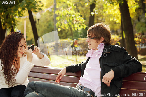 Image of Woman photographs guy