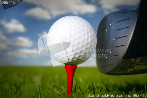 Image of Golf club and ball in grass 