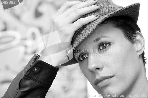 Image of Woman holding her hat