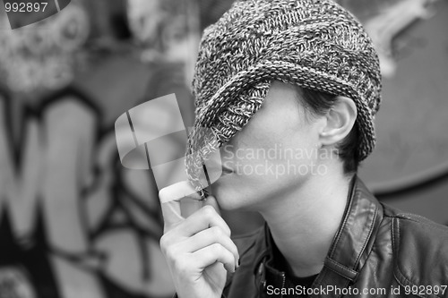 Image of Woman hiding behind her cap