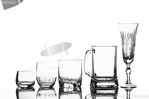 Image of Various glass glasses on a white background with reflexion