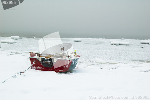 Image of Fishing boat on the bank of the frozen sea