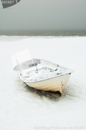 Image of Fishing boat on the bank of the frozen sea