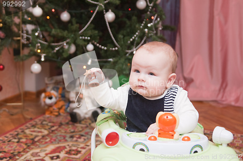 Image of The kid at a New Year tree