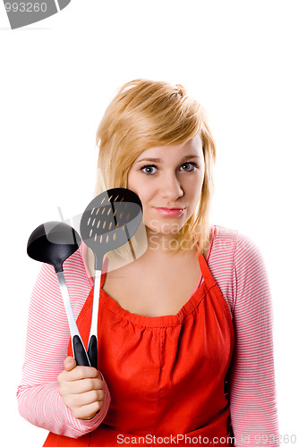 Image of young housewife with kitchen utensil