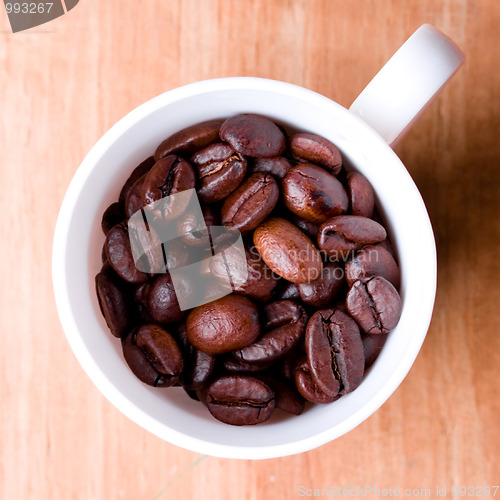 Image of cup full of coffee beans