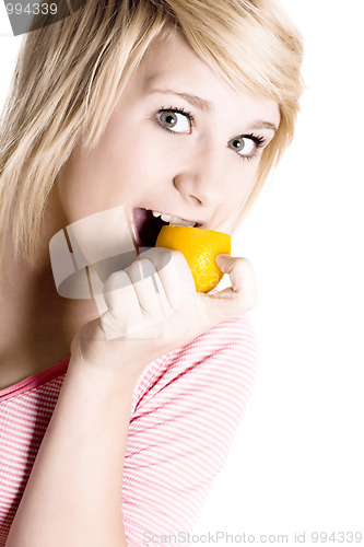 Image of girl eating lemon