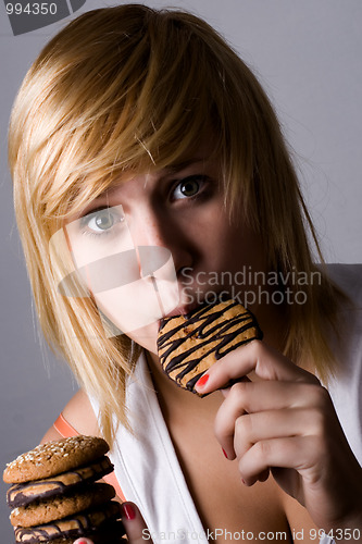 Image of woman eating chocolate chip cookies