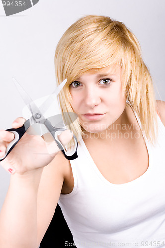 Image of attractive young woman with scissors