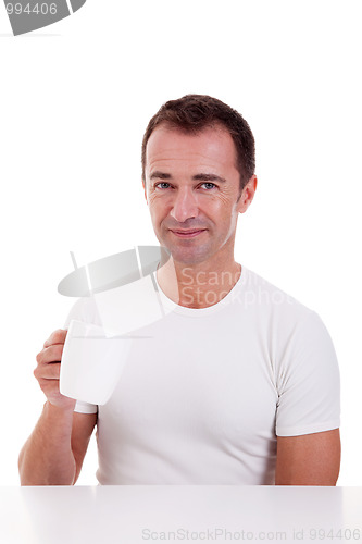 Image of Portrait of a happy man, drinking a drink