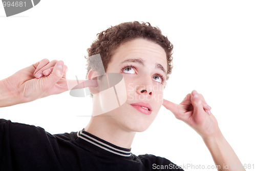 Image of Young man, holding fingers in his ears, bored, not listening