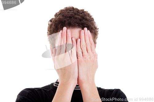 Image of young man covering his face