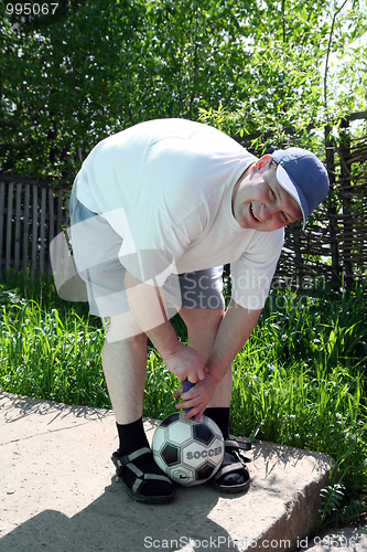 Image of man pump soccer football ball