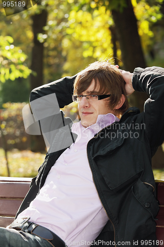 Image of Young pensive man in park