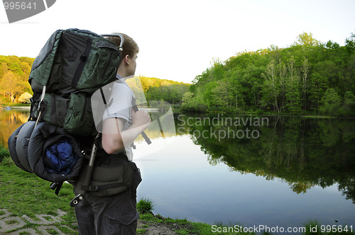 Image of Teenage hiker standing by Sunrise Lake