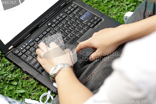 Image of Man using a laptop outdoors