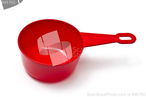 Image of Red plastic measuring cup isolated on white