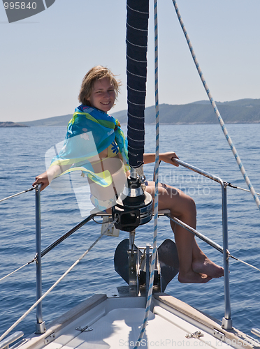 Image of woman sitting on yacht nose