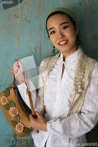 Image of Asian woman holding a handbag