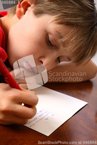 Image of Boy writing note letter to santa