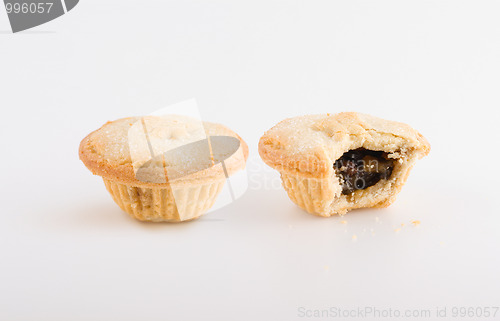 Image of Two fruit pies, one bitten