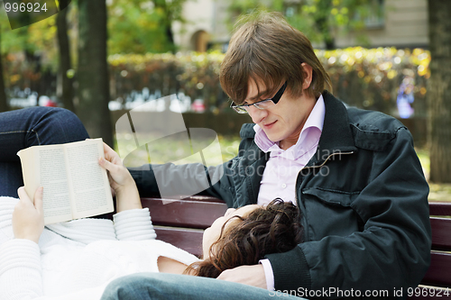 Image of Relaxed couple with book