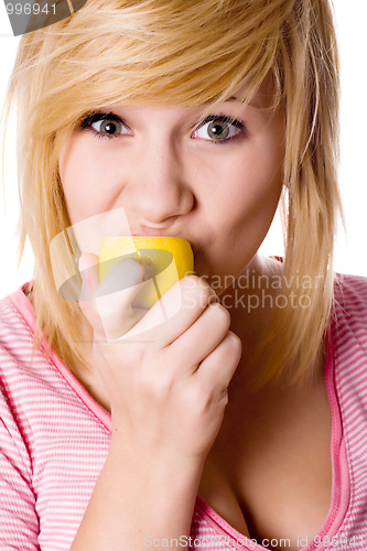 Image of girl eating lemon